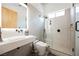 Modern bathroom with sleek floating sink, rainfall shower head in glass shower, and tiled walls at 5077 Thunder River Cir, Las Vegas, NV 89148