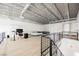Spacious loft bedroom with a comfortable lounge area, large windows, and an open floor plan with industrial-style ceiling at 5077 Thunder River Cir, Las Vegas, NV 89148