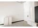 Minimalist entryway with white walls, concrete floors, and a modern storage unit at 5077 Thunder River Cir, Las Vegas, NV 89148