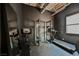 Modern exercise room with dark walls featuring a treadmill, weight rack and bike for a complete workout at 5077 Thunder River Cir, Las Vegas, NV 89148