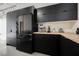 Sleek, modern kitchen featuring stainless steel appliances, black cabinetry and modern countertops at 5077 Thunder River Cir, Las Vegas, NV 89148