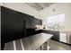 Modern kitchen featuring black cabinetry, stainless steel appliances, and butcher block countertops at 5077 Thunder River Cir, Las Vegas, NV 89148