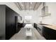 Bright, modern kitchen with black cabinets, stainless steel appliances, and an industrial ceiling at 5077 Thunder River Cir, Las Vegas, NV 89148