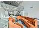 Open-plan living room with high ceilings, metal beams, an orange sofa set, and view of kitchen and dining area at 5077 Thunder River Cir, Las Vegas, NV 89148