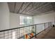 Second floor view of large window, orange couches and high ceiling of bright, airy living room at 5077 Thunder River Cir, Las Vegas, NV 89148