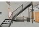 Modern staircase with steel railings and a stylish bar area beneath at 5077 Thunder River Cir, Las Vegas, NV 89148
