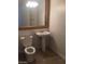 Cozy half-bathroom featuring a pedestal sink, toilet, and mirror with wood trim at 5147 Villa Vecchio Ct, Las Vegas, NV 89141