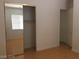 Bedroom with mirrored closet doors, hardwood flooring, and natural light at 5147 Villa Vecchio Ct, Las Vegas, NV 89141