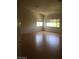 Spacious bedroom with hardwood floors and lots of natural light from the large windows at 5147 Villa Vecchio Ct, Las Vegas, NV 89141