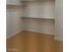 Walk-in closet featuring shelving to maximize storage space and hardwood floor for easy maintenance at 5147 Villa Vecchio Ct, Las Vegas, NV 89141