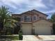 Lovely stucco house with a two-car garage, terracotta roof, and well-maintained landscaping at 5147 Villa Vecchio Ct, Las Vegas, NV 89141