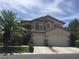 Charming two-story home with a well-manicured lawn, mature palm trees, and a large two-car garage at 5147 Villa Vecchio Ct, Las Vegas, NV 89141