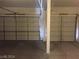 Spacious three car garage featuring three doors and concrete flooring at 5147 Villa Vecchio Ct, Las Vegas, NV 89141