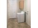 Functional laundry room with white appliances, a white door, and neutral flooring at 5147 Villa Vecchio Ct, Las Vegas, NV 89141