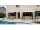 Backyard pool with decorative iron shade and a lounge area, perfect for outdoor entertaining and relaxation at 5147 Villa Vecchio Ct, Las Vegas, NV 89141