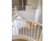 Elegant staircase with white railings, leading to the upper levels of the home, and ceramic tile on the floor at 5147 Villa Vecchio Ct, Las Vegas, NV 89141
