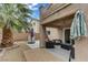Inviting patio with outdoor seating, a shade umbrella, and beautiful landscaping for a relaxing backyard experience at 5213 Welch Valley Ave, Las Vegas, NV 89131