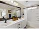 Bathroom featuring double sinks, modern fixtures, a shower and a decorative mirror at 5213 Welch Valley Ave, Las Vegas, NV 89131