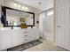 Bright bathroom featuring double sinks, modern fixtures, a shower and tile flooring at 5213 Welch Valley Ave, Las Vegas, NV 89131