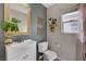 Cozy bathroom with a white sink, matching toilet, framed mirror and neutral wall color at 5213 Welch Valley Ave, Las Vegas, NV 89131