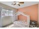 Bright bedroom with a canopy bed, plush carpets, and an exterior view at 5213 Welch Valley Ave, Las Vegas, NV 89131