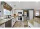 Well-lit kitchen with white cabinets, stainless steel appliances, and decorative accents, blending style with functionality at 5213 Welch Valley Ave, Las Vegas, NV 89131