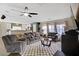 Comfortable living room with plush seating, ceiling fan, and open layout to the kitchen creates a cozy gathering space at 5213 Welch Valley Ave, Las Vegas, NV 89131