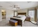 Spacious main bedroom features a ceiling fan, a bench, two windows, and carpeted floors at 5213 Welch Valley Ave, Las Vegas, NV 89131