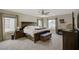 Spacious main bedroom features a ceiling fan, a bench, two windows, and carpeted floors at 5213 Welch Valley Ave, Las Vegas, NV 89131