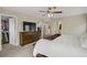 Spacious main bedroom with TV features neutral colors, ceiling fan, and carpeted floors at 5213 Welch Valley Ave, Las Vegas, NV 89131