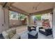 A charming outdoor space featuring comfortable seating, ambient lighting, and a verdant palm tree at 5213 Welch Valley Ave, Las Vegas, NV 89131