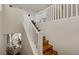 Staircase with wooden steps and white railing leads to the upper level, brightening up the home's interior at 5213 Welch Valley Ave, Las Vegas, NV 89131