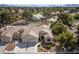 Beautiful aerial shot of a single-Gathering home with lush landscaping, a two-car garage, and desert surroundings at 5240 Las Cruces Dr, Las Vegas, NV 89130