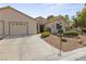 Charming single-story home with a well-manicured front yard and a two-car garage at 5240 Las Cruces Dr, Las Vegas, NV 89130