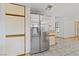 Modern kitchen with stainless steel refrigerator and tile flooring at 5240 Las Cruces Dr, Las Vegas, NV 89130