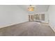 Large living area featuring plush carpeting, a ceiling fan, and ample lighting at 5240 Las Cruces Dr, Las Vegas, NV 89130