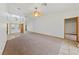 Open-concept living space with high ceilings, carpeted flooring, and tile entry at 5240 Las Cruces Dr, Las Vegas, NV 89130