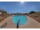 A community pool surrounded by lounge chairs and palm trees at 5240 Las Cruces Dr, Las Vegas, NV 89130