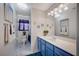 Bathroom with a marble floor, blue vanity, and a separate toilet and tub at 5508 Lochmor Ave, Las Vegas, NV 89130
