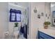 Bathroom with a marble floor, blue vanity, and a separate toilet and tub at 5508 Lochmor Ave, Las Vegas, NV 89130