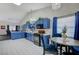 Open concept kitchen with blue cabinets, black appliances, and a view to the dining area at 5508 Lochmor Ave, Las Vegas, NV 89130