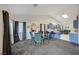 Open-concept living room featuring a dining area and kitchen with blue cabinets at 5508 Lochmor Ave, Las Vegas, NV 89130