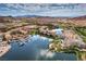 Breathtaking aerial view of the community showcasing the lake, mountains, and buildings at 56 Tatahatso Point St, Henderson, NV 89011