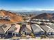 Stunning aerial view of houses in a desert community near mountains with a lake in the distance at 56 Tatahatso Point St, Henderson, NV 89011