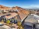An aerial view features modern homes with solar panels in a desert setting at 56 Tatahatso Point St, Henderson, NV 89011