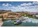Beautiful aerial view of a lakeside community with Mediterranean-style buildings, a boat launch, and mountain scenery at 56 Tatahatso Point St, Henderson, NV 89011