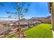 Well-maintained backyard featuring lush turf, desert landscaping, and community views at 56 Tatahatso Point St, Henderson, NV 89011