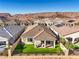 Landscaped backyard with artificial turf and mountain views at 56 Tatahatso Point St, Henderson, NV 89011