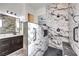 Modern bathroom with a sleek walk-in shower featuring stylish tile and accessibility features at 56 Tatahatso Point St, Henderson, NV 89011