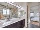 Luxurious bathroom featuring double sinks, a walk-in shower, and modern finishes at 56 Tatahatso Point St, Henderson, NV 89011
